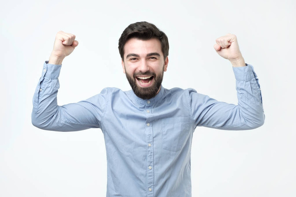Portrait of happy spanish man with fists up celebrating his victory.Great news ever. - Photo, Image