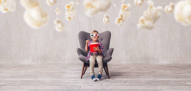 Happy boy in 3d glasses with popcorn in cinema - Photo, Image