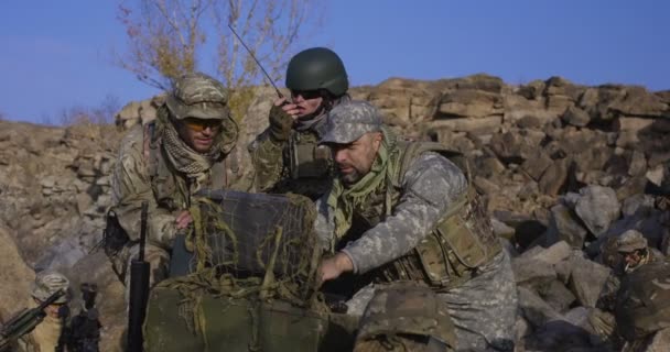 Armed soldiers looking at a computer - Footage, Video