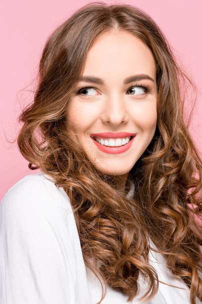 The happy business woman standing and smiling against pink background. - Foto, Imagen