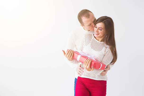 Christmas, holidays, Valentines day and birthday concept - Close up of man and woman holds box with gift on white background with copy space - Foto, Imagem