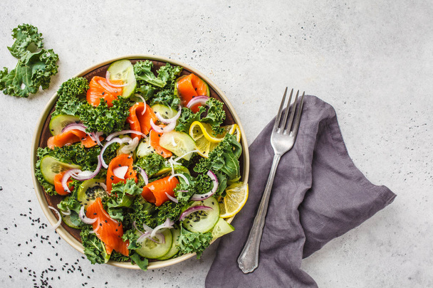 Salted salmon (trout) and Kale salad in a white plate on a white background. Healthy food concept. - Foto, Imagem