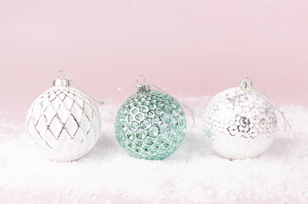 Vintage Christmas New Year balls in the snow on pink background Flat Lay copy space. Holiday Baubles, beautiful Decoration Festive decor celebration Xmas holiday greeting card - Foto, Imagen
