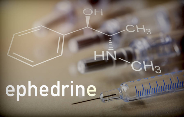 Chemical composition of ephedrine next to syringe, conceptual image - Photo, Image