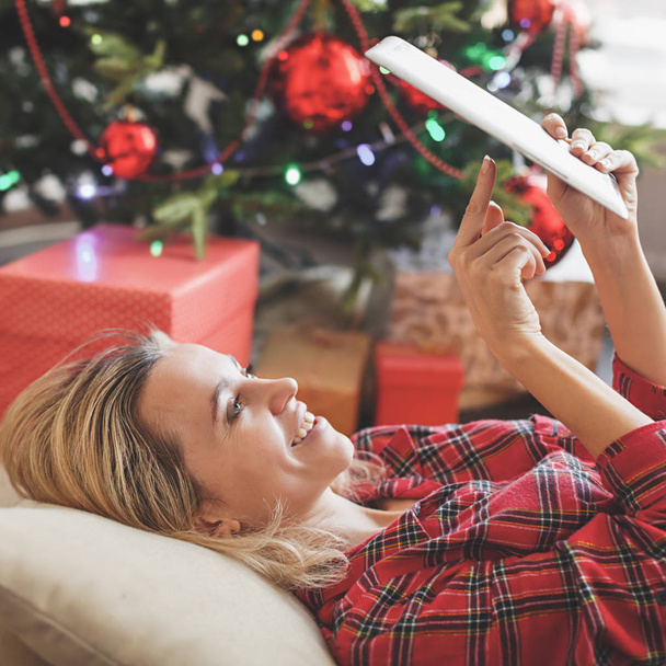 Woman with tablet near christmas tree - Photo, Image
