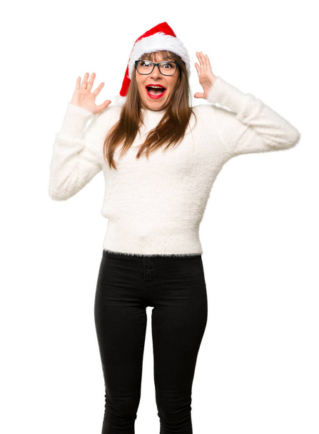Girl with celebrating the christmas holidays with surprise and shocked facial expression on isolated white background - Foto, imagen