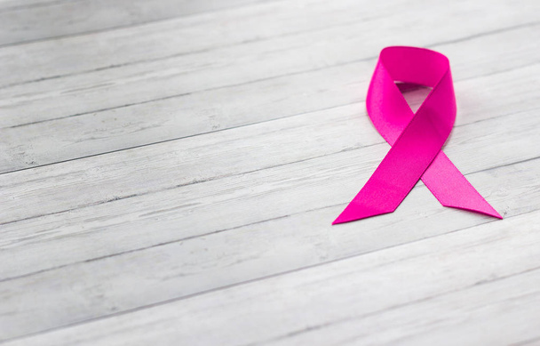 Pink ribbon on wooden background, female health concept - Foto, Imagem