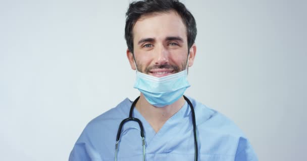 close up portrait of a surgeon or doctor with mask and headset ready for operation in hospital or clinic. The surgeon smiles safe and proud of himself. Concept of medicine, hospitals and doctors, care - Filmmaterial, Video