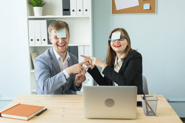 Business, break and people concept - Cheerful man and woman playing games in office while working - Foto, Imagen