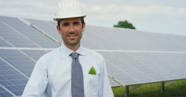 slow motion video of businessman gesturing thumbs up while standing at eco solar panels, roof cells solar system station - Filmmaterial, Video