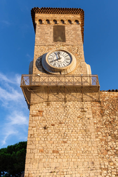 View to an old bell tower in the city of Cannes. Close up photo. Shot at dawn. No clouds. History of France - Fotó, kép