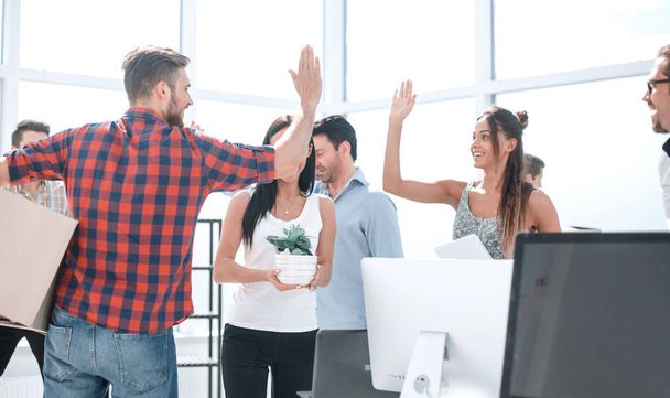 business team is giving each other a high five in the new office - Photo, image