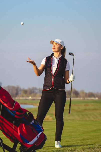 Young beautiful woman is training golf - Fotó, kép