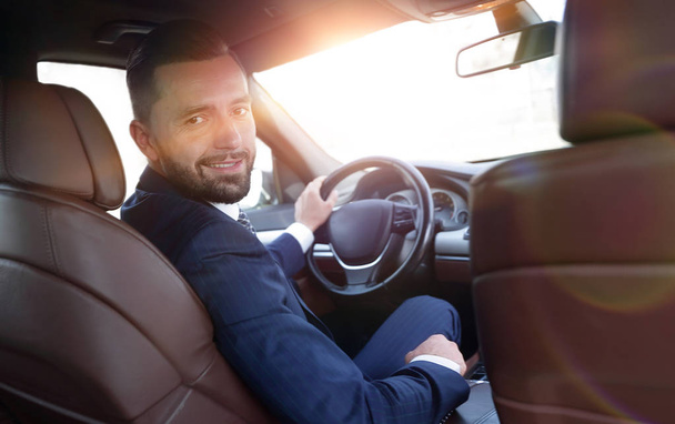 businessman sitting at the wheel of a prestigious car - Φωτογραφία, εικόνα