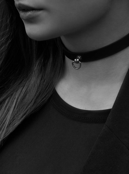 Black leather choker on the neck of the girl. - Photo, Image
