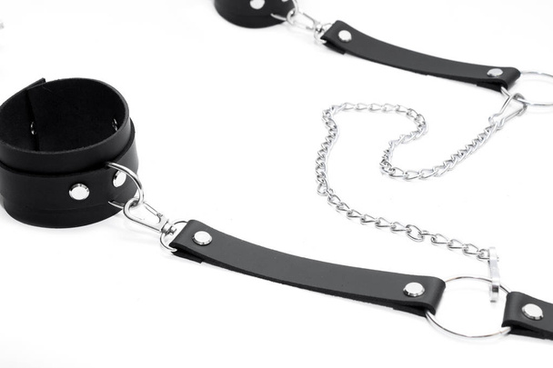 Black leather handcuffs isolated on white background. BDSM Kit - Foto, Imagem