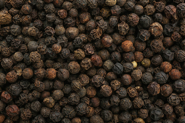 Black pepper corns as background. Natural spice - Foto, Bild