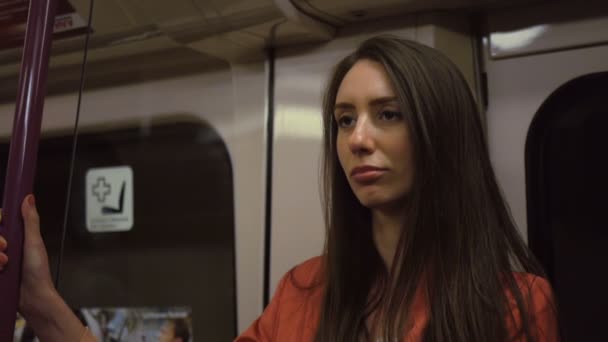 A tired woman in a suit returns home by train late at night - Footage, Video