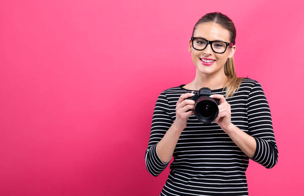Young woman with a professional camera - Photo, Image