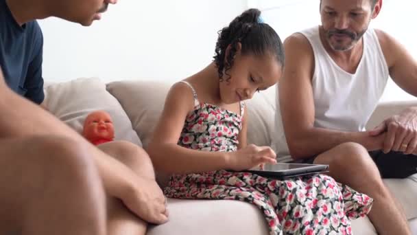 Семья геев с усыновленным ребенком с помощью планшета дома
 - Кадры, видео