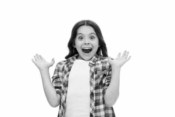 Child with open mouth on surprised face isolated on white. Kid with long brunette hair and beauty look. Funky emotions. Little girl in casual style. Surprise - 写真・画像