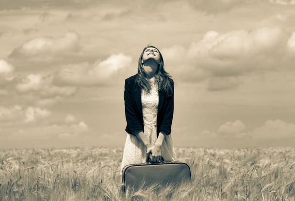 girl with suitcase at wheat field - Φωτογραφία, εικόνα