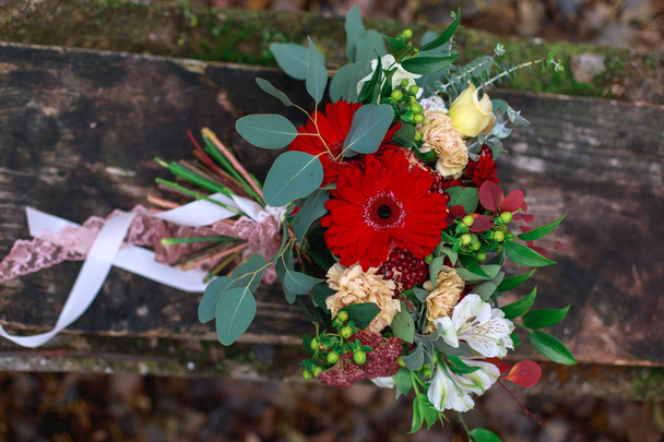 Wedding bouquet of flowers including Red hypericum, Roses, Lilies of the valley, mini Roses, Seeded Eucalyptus, Astilbe, Scabiosa, Pieris, and ivy - Foto, Bild