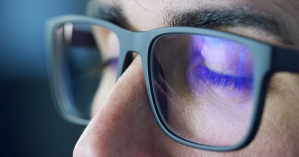 Close up of young businessman with blue eyes wearing the glasses looking on waveform lines of stock market, augmented reality, technology, stock exchange  and finance - Séquence, vidéo