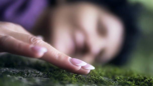 Beautiful woman lying on the meadow smiling and dreaming. Enjoy nature. Beauty girl on the green moss grass outdoors. Spring or summer lawn. Cinematic dof, perfect for commercial or video clip - Metraje, vídeo