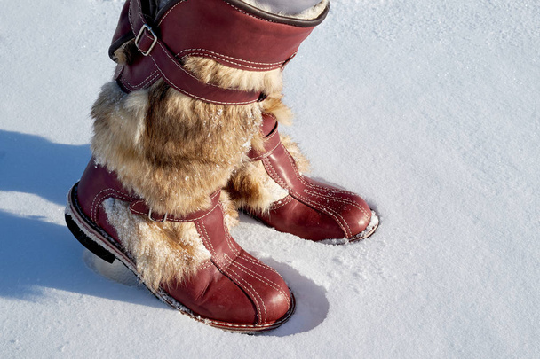 northern national fur boots in the snow winter - Фото, изображение