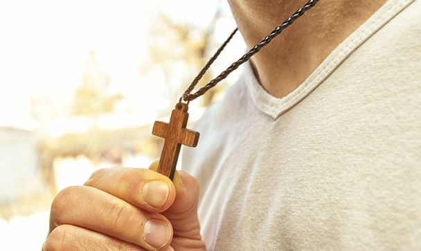The wooden cross necklace on man's neck - Foto, immagini