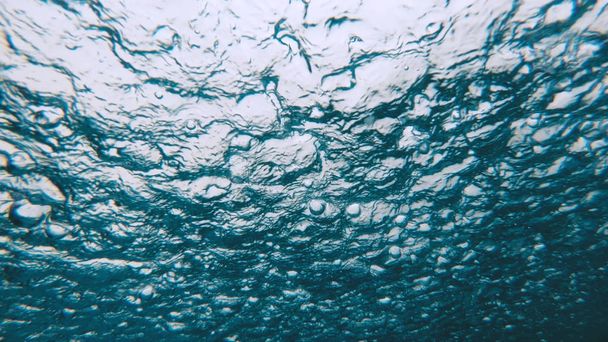 Underwater view of heavy raining into the water surface - Фото, зображення