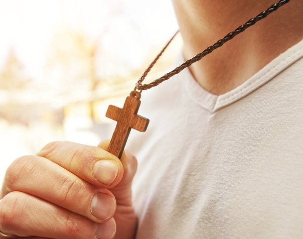 The wooden cross necklace on man's neck - Foto, immagini