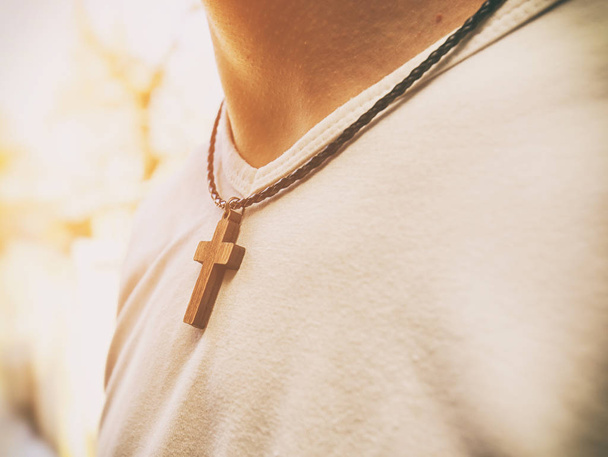 The wooden cross necklace on man's neck - Zdjęcie, obraz