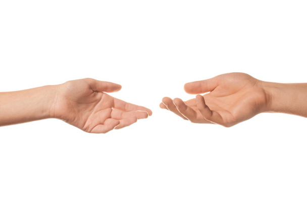 Male and female hands reaching out to each other on white background - Photo, image