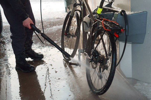 washing the bike, washing the bike with a hose under pressure - Photo, Image