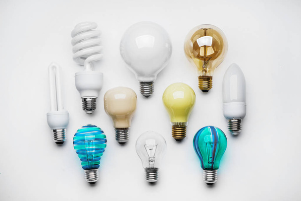 Composition with different light bulbs on white background - Photo, Image
