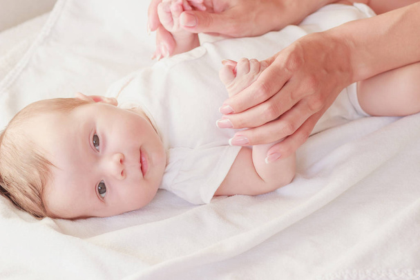 Baby and hands of mother, indoors, soft focus background - Photo, Image