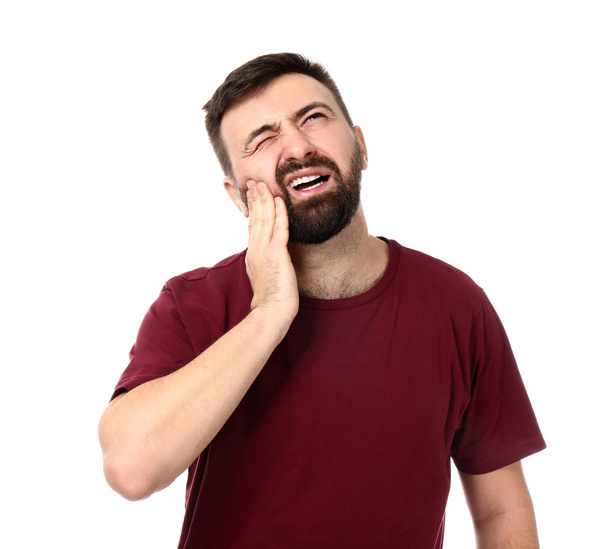 Man suffering from toothache on white background - Photo, image