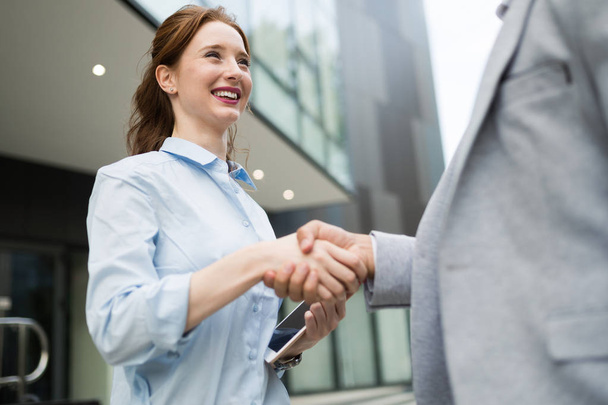 Successful young business people handshaking closing a deal - Photo, Image