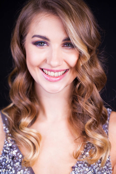 Close-up portrait of beautiful model with long blond hair on black background - Φωτογραφία, εικόνα