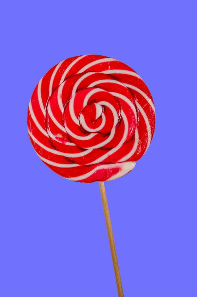 Sweet red lollipop on blue background - Photo, Image
