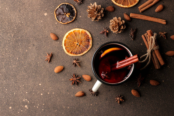 Hot mulled wine with cinnamon and orange on a dark background. view from above. Christmas. new Year. - Photo, Image