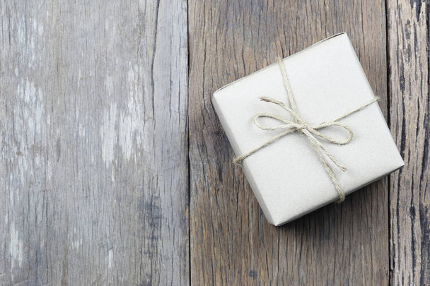 Brown Gift Box on wooden floor and have copy space for design in Christmas concept. - 写真・画像