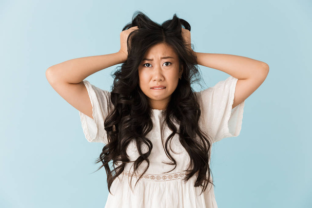 Image of shocked scared young asian beautiful woman posing isolated over blue background. - Fotografie, Obrázek