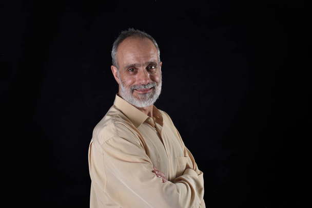 portrait of middle aged man on black - Photo, Image