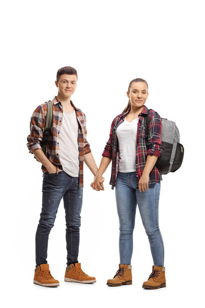 Full length portrait of a male and female students holding hands isolated on white background - Fotografie, Obrázek