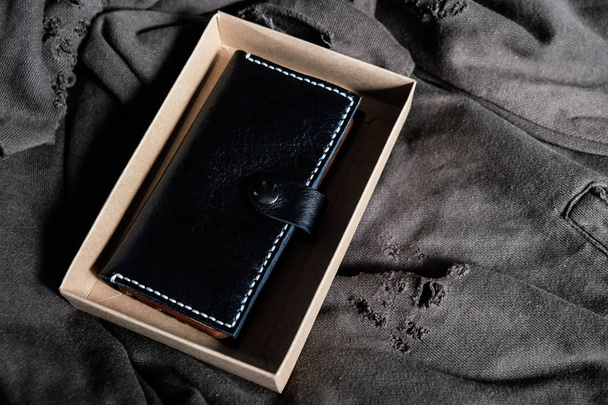 Genuine smartphone case with wallet handmade in paper box on vintage cloth - Photo, Image