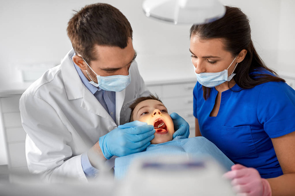 dentist checking for kid teeth at dental clinic - Valokuva, kuva