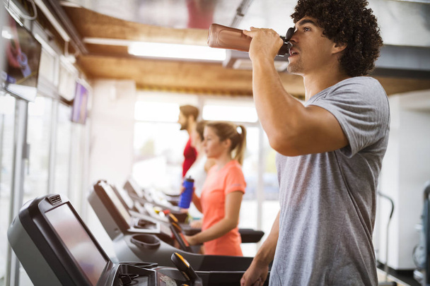 Group of friends exercising on treadmill machine in gym - Zdjęcie, obraz